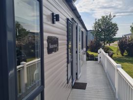 An outdoor area with a deck and entrance to a building at Seashore Holiday Park - Holiday Accommodation 20465 Great Yarmouth