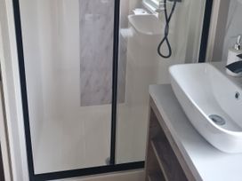 A bathroom with a shower and sink at Seashore Holiday Park - Holiday Accommodation 20465 in Great Yarmouth