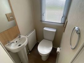 A bathroom with a toilet and sink at Hafan y Mor Haven - Holiday Accommodation 20501 in Pwllheli