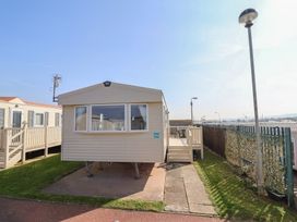 A mobile home with a deck and steps at Golden Sands Kinmel Bay - 20528 Rhyl