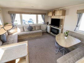 A living room with a sofa and television at Golden Sands Kinmel Bay - 20528, Rhyl
