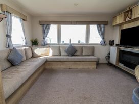 A living room with a sofa and television at Golden Sands Kinmel Bay - 20528 Rhyl