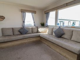 A snug with a corner sofa and window at Golden Sands Kinmel Bay - 20528, Rhyl