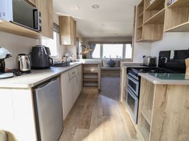 A kitchen with appliances and storage at Golden Sands Kinmel Bay - 20528 Rhyl