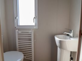 A bathroom with a toilet and sink at Golden Sands Kinmel Bay - 20528 Rhyl