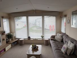 A living room with a sofa and coffee table at Liskey Hill Caravan Park - Holiday Accommodation 20540, Perranporth