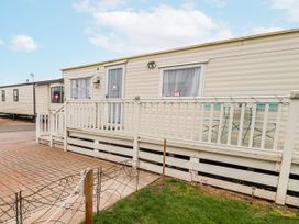 A caravan with steps and decking at Golden Gate Holiday Centre - Holiday Accommodation 20618 in Abergele