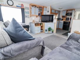 A living room with a sofa and television at Golden Gate Holiday Centre - Holiday Accommodation 20618 Abergele