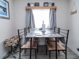 A dining room with a table and chairs at Golden Gate Holiday Centre - Holiday Accommodation 20618 in Abergele
