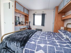 A bedroom with a bed and storage cabinets at Golden Gate Holiday Centre - Holiday Accommodation 20618 Abergele