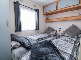 A bedroom with two beds and a window at Golden Gate Holiday Centre - Holiday Accommodation 20618 Abergele