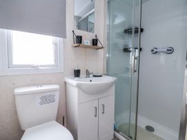 A bathroom with a toilet, sink, and shower at Golden Gate Holiday Centre - Holiday Accommodation 20618 Abergele