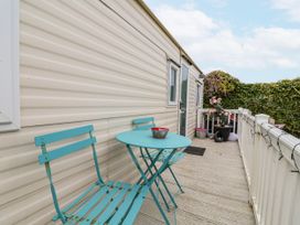 An outdoor seating area with a table and chairs at Golden Gate Holiday Centre - Holiday Accommodation 20618 Abergele