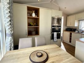 A kitchen with a dining table and chairs at Thornwick Bay Holiday Village - Holiday Accommodation 20633 Flamborough