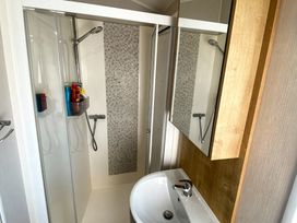 A bathroom with a shower and sink at Thornwick Bay Holiday Village - Holiday Accommodation 20633 Flamborough