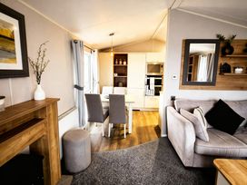 A living room with a table and chairs at Thornwick Bay Holiday Village - Holiday Accommodation 20633, Flamborough