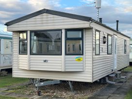 A caravan with windows and a door at Seaview Caravan Park - Holiday Accommodation 20846 Ingoldmells, Skegness
