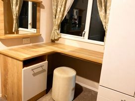 A study area with a desk and chair at Lyons Robin Hood - Holiday Accommodation 20871 in Rhyl
