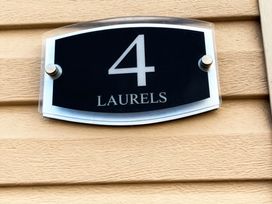 A number 4 nameplate mounted on a wall at Lyons Robin Hood - Holiday Accommodation 20871 Rhyl