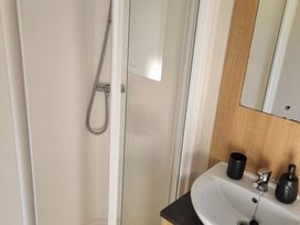 A bathroom with a shower and sink at Trecco Bay - Holiday Accommodation 20876, Porthcawl