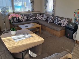 A living room with a sofa and coffee table at Trecco Bay - Holiday Accommodation 20876, Porthcawl