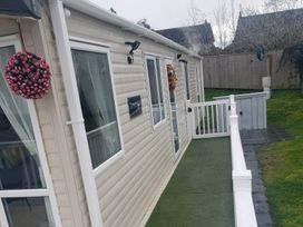 An outdoor view of a cabin with a decorative flower arrangement at Marton Mere Holiday Village - Holiday Accommodation 20877, Blackpool