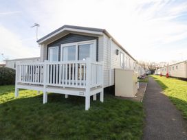 A holiday home with a deck and pathway at Cala Gran Holiday Park - Holiday Accommodation 20962 Fleetwood
