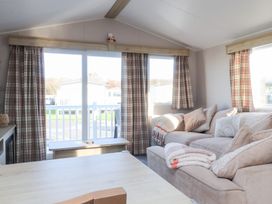 A living room with a sofa and coffee table at Cala Gran Holiday Park - Holiday Accommodation 20962 Fleetwood