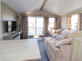 A living room with a sofa and television at Cala Gran Holiday Park - Holiday Accommodation 20962, Fleetwood
