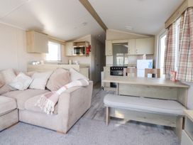 A living room with a sofa and dining area at Cala Gran Holiday Park - Holiday Accommodation 20962 Fleetwood