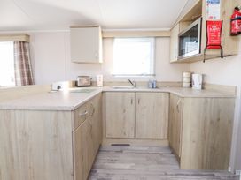 A kitchen with a sink and microwave at Cala Gran Holiday Park - Holiday Accommodation 20962 Fleetwood