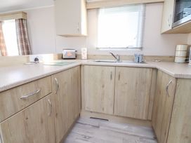 A kitchen with cabinets and a sink at Cala Gran Holiday Park - Holiday Accommodation 20962 Fleetwood