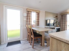 A dining area with a table and chairs at Cala Gran Holiday Park - Holiday Accommodation 20962 in Fleetwood