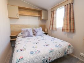 A bedroom with a bed and window at Cala Gran Holiday Park - Holiday Accommodation 20962 Fleetwood