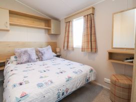 A bedroom with a bed and a desk at Cala Gran Holiday Park - Holiday Accommodation 20962 Fleetwood
