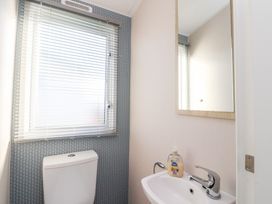 A bathroom with a toilet and sink at Cala Gran Holiday Park - Holiday Accommodation 20962, Fleetwood