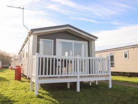 A static caravan with a deck at Cala Gran Holiday Park - Holiday Accommodation 20962 Fleetwood
