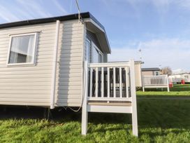 A house with a deck and railing at Cala Gran Holiday Park - Holiday Accommodation 20962 Fleetwood