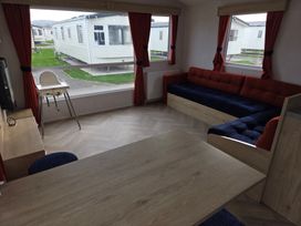 A living room with a couch and table at Ty Mawr Holiday Park - Holiday Accommodation 21121 Ty Mawr