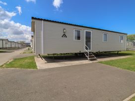A static caravan with steps and windows at Ty Mawr Holiday Park - Holiday Accommodation 21121 Ty Mawr