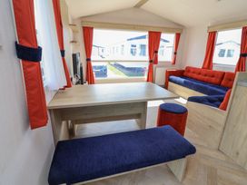 A living room with a table and sofa at Ty Mawr Holiday Park - Holiday Accommodation 21121, Ty Mawr