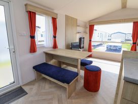 A dining area with a table and chairs at Ty Mawr Holiday Park - Holiday Accommodation 21121 Ty Mawr