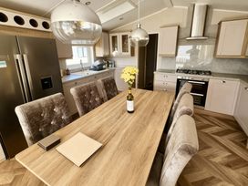 A kitchen with a table and chairs at Ocean Edge Leisure Park - Holiday Accommodation 21286, Morecambe