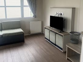 A living room with a sofa and television at Cala Gran Holiday Park - Holiday Accommodation 21402 Fleetwood