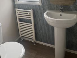 A bathroom with a sink, toilet, and radiator at Cala Gran Holiday Park - Holiday Accommodation 21402 in Fleetwood