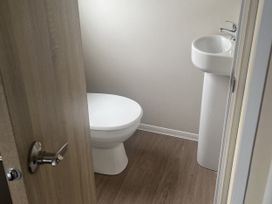 A bathroom with a toilet and sink at Cala Gran Holiday Park - Holiday Accommodation 21402, Fleetwood