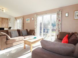 A living room with sofas and a coffee table at St Minver Holiday Park - Holiday Accommodation 21443, Wadebridge