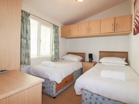 A bedroom with two beds and a window at St Minver Holiday Park - Holiday Accommodation 21443 Wadebridge
