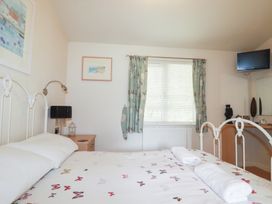 A bedroom with a bed and television at St Minver Holiday Park - Holiday Accommodation 21443, Wadebridge