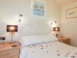 A bedroom with a bed and lamps at St Minver Holiday Park - Holiday Accommodation 21443 Wadebridge